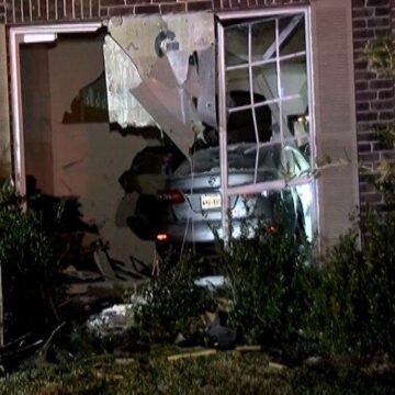 CAR DRIVES THROUGH HOUSE