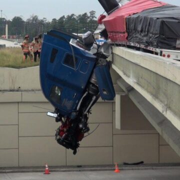 TWO COMMERCIAL VEHICLES GO OVER THE SIDE OF OVERPASS ONTO ROADWAY BELIOW IN SPRING-ONE DRIVER CRITICAL